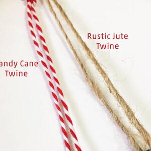 May include: Two types of twine, one red and white, labelled "Candy Cane Twine", and the other natural brown, labelled "Rustic Jute Twine".