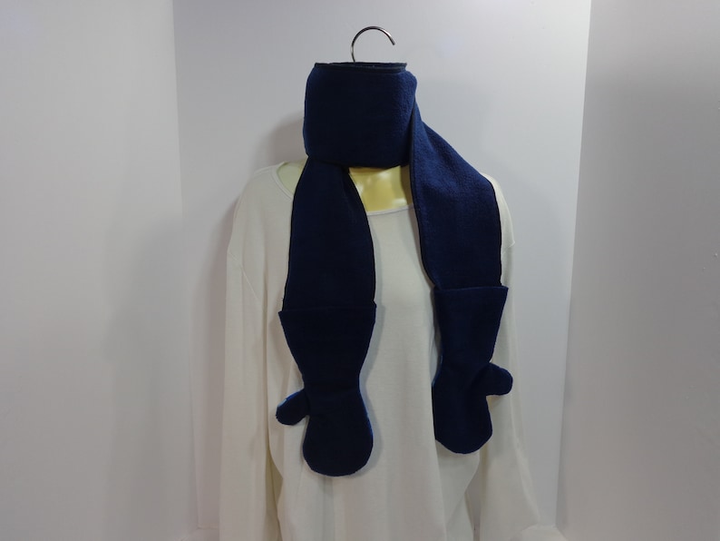 Each scarf has a mitten attached to each end of the scarf These scarfmittens set come as a one piece item creating a one piece garment.
