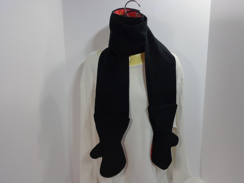 Each scarf has a mitten attached to each end of the scarf These scarfmittens set come as a one piece item creating a one piece garment.