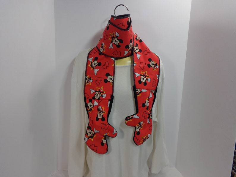 Each scarf has a mitten attached to each end of the scarf These scarfmittens set come as a one piece item creating a one piece garment.