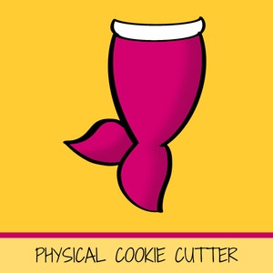 May include: Pink mermaid tail cookie cutter with a white top fin.  PHYSICAL COOKIE CUTTER is written in black text at the bottom of the image.