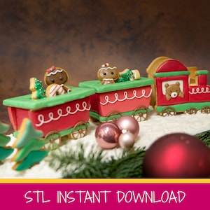 May include: A gingerbread train with three cars, each decorated with a gingerbread person and a green tree. The train is on a white surface with red and pink ornaments.