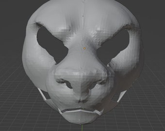 May include: A three-dimensional digital model of a feline head featuring a grey, low-poly surface with visible geometric facets. The design includes large, hollow eye sockets, a prominent snout, and a defined mouth area, presented on a grid.
