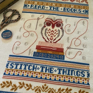 May include: Cross stitch pattern featuring an owl sitting on a stack of books with the text "Read the books" and "Stitch the things" in a colorful, vintage style.