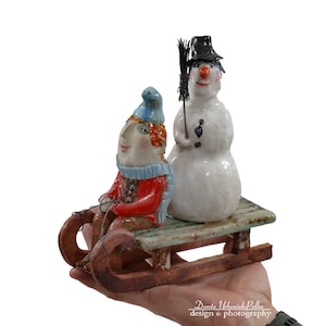 Ceramic Snowman Sculpture: Little Jo and Sled, &quot;Parallel World&quot; Collection