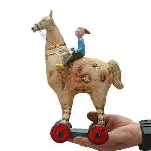 Horse with red wheels - On the roads of the world - standing ceramic sculpture