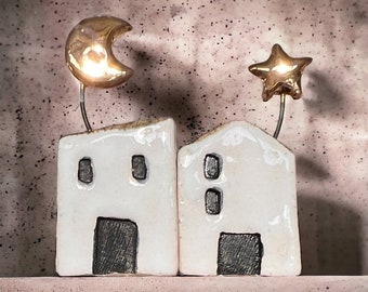 White ceramic house with golden star or moon, Christmas decoration