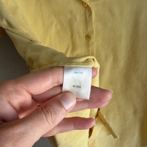 May include: A set of three ceramic mugs with a speckled, matte finish. The mugs are in shades of cream, light gray, and dark gray. Each mug has a simple, minimalist design and a rounded handle.