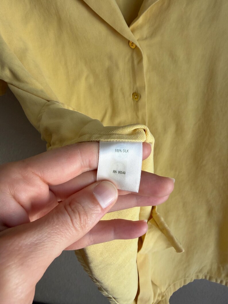 May include: A set of three ceramic mugs with a speckled, matte finish. The mugs are in shades of cream, light gray, and dark gray. Each mug has a simple, minimalist design and a rounded handle.