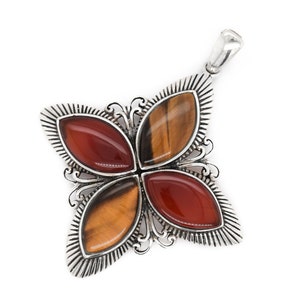 May include: A silver pendant with a four-petal design. Each petal features a polished gemstone: two are reddish-brown, and two are tiger's eye with brown and gold stripes. The pendant has a decorative silver border and a bail for a chain.