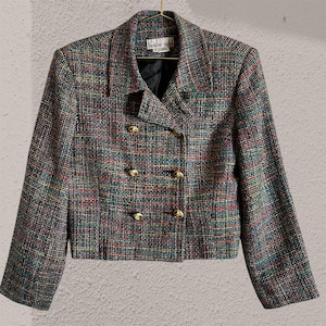 May include: A multi-coloured tweed blazer with gold buttons. The jacket has a double-breasted design and a classic collar. The label reads "helene sidel". The tweed fabric features a mix of red, blue, green, and yellow threads.