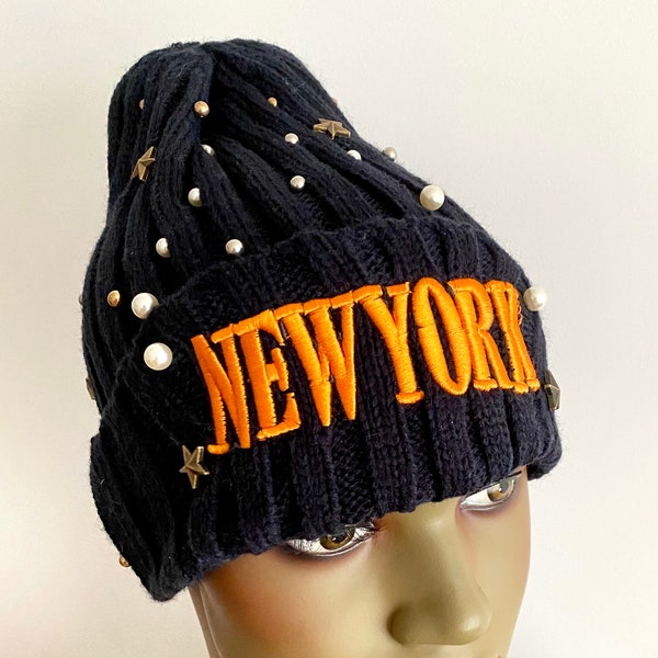 Navy blue knitted hat with orange lettering.  navy blue knitted beanie.  women’s hats.  navy blue winter hat.