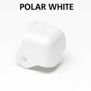 May include: A white, rounded corner bracket with two holes. The text "POLAR WHITE" is displayed above the bracket. The bracket has a smooth, glossy finish and is designed for structural support or aesthetic purposes.