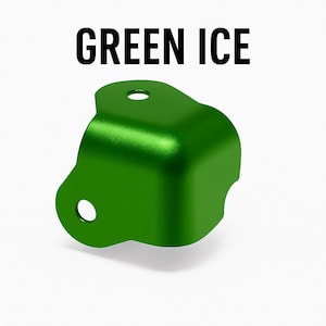 May include: A bright green, metallic-looking object with two circular holes. The object has a curved, angular shape and the text "GREEN ICE" is displayed in bold, black letters above it.