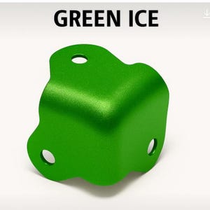 May include: A bright green, angular metal object with three circular holes. The text "GREEN ICE" is displayed above the object. The object has a textured surface and a unique, curved shape.