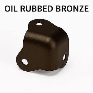 May include: Oil rubbed bronze corner bracket with three pre-drilled holes. The bracket is a dark brown color and has a rounded corner design. The text "OIL RUBBED BRONZE" is printed at the top of the image.