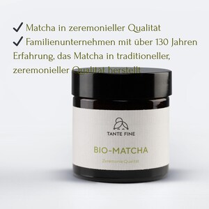 May include: A dark brown glass jar with a black lid and a white label. The label features a line-art logo of a person, the text TANTE FINE, BIO-MATCHA, and Zeremonie Qualit&auml;t. Above the jar, text reads Matcha in zeremonieller Qualit&auml;t.