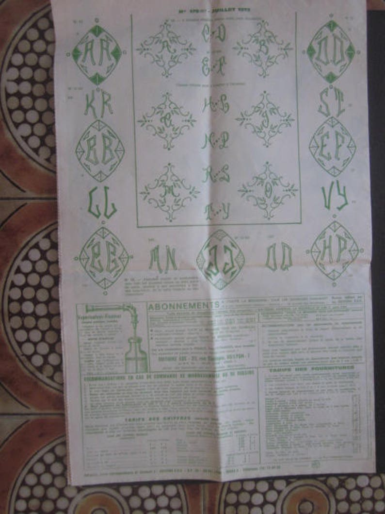 May include: A black and white page with a green and white design. The page has a list of letters and numbers with a green border. The page also has a section titled "ABONNEMENTS" and "TARIFS DES FOURNITURES".