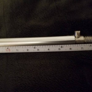 May include: A silver metal rod with a threaded end, measured at 7 inches long.