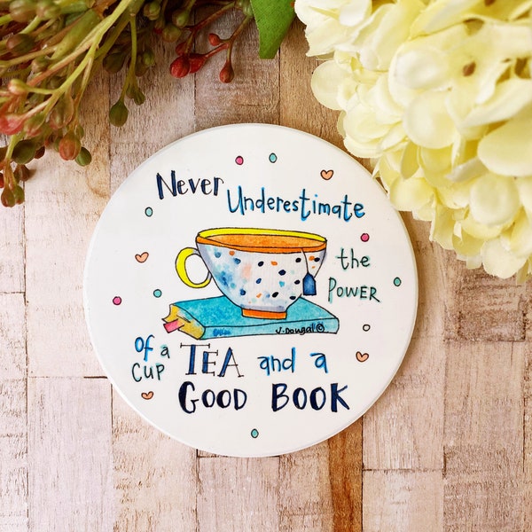 Never Underestimate a cup of tea and a good book Ceramic Coaster