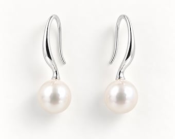 May include: A pair of silver-toned drop earrings featuring a smooth, curved metal hook design that transitions into a single, round, lustrous white pearl at the base. The earrings have a polished, reflective finish and a simple, elegant structure.
