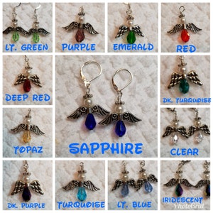 May include: A set of silver angel dangle earrings with a variety of colored crystal drops. The colors include light green, purple, emerald, red, deep red, dark turquoise, topaz, sapphire, clear, dark purple, turquoise, light blue, and iridescent.