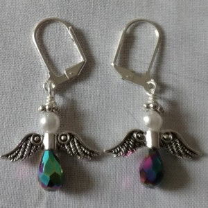May include: A pair of silver angel wing earrings with iridescent teardrop crystals and white pearl beads.