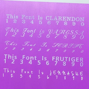May include: A purple card with five different fonts displayed. Each font is labeled with its name and includes the numbers 1 through 9 and 0. The fonts are Clarendon, Vanessa, Script, Frutiger, and Jennasue.