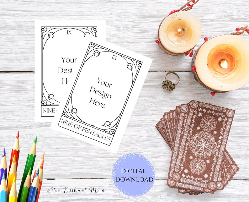 May include: Two printable tarot card templates with a black and white outline of a nine of pentacles card. The text "Your Design Here" is in the center of the card. The text "Nine of Pentacles" is at the bottom of the card. The cards are on a white wooden surface with candles and a deck of tarot cards.