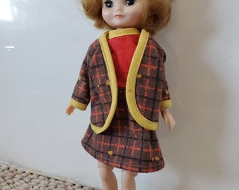 Original vintage 1950s Betsy McCall doll, 8 in, strawberry blonde hair wearing brown, red, and yellow school girl outfit, black shoes, joint
