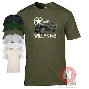 May include: A green t-shirt featuring a white star and a cartoon image of a green military jeep with the text "WILLYS MB" printed on the front.