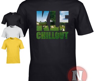 May include: Black t-shirt with a white, blue, and green graphic print of the text "K.L.F. Chillout" with a field of sheep in the background.