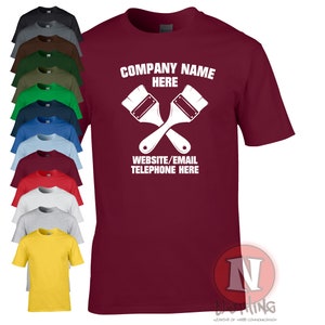 May include: A maroon t-shirt with a white design of two paintbrushes crossed over each other. The text "COMPANY NAME HERE" is above the paintbrushes and the text "WEBSITE/EMAIL TELEPHONE HERE" is below the paintbrushes.