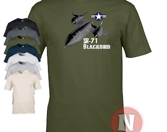 May include: A green t-shirt with a black and white image of an SR-71 Blackbird airplane. The airplane is flying with the US Air Force star and stripes insignia on the tail. The text "SR-71 BLACKBIRD" is printed below the airplane.
