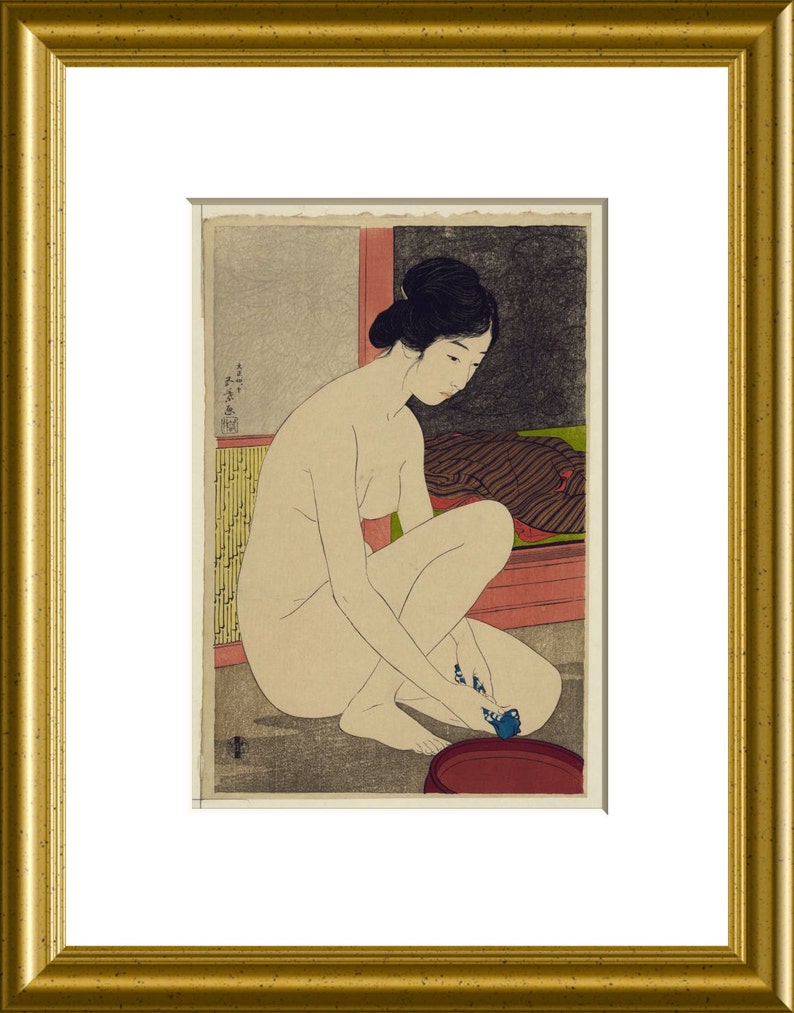 May include: A framed Japanese woodblock print depicting a figure with dark hair styled in an updo, crouching while washing feet in a dark red basin. The scene features a textured gray floor, a yellow bamboo-patterned screen, and a dark cloth.
