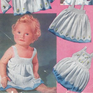 May include: A vintage knitting pattern for a baby cardigan, dress, and bonnet. The pattern includes instructions for knitting a white cardigan with blue trim and yellow flower accents, a white dress with blue trim and yellow flower accents, and a white bonnet with blue trim.