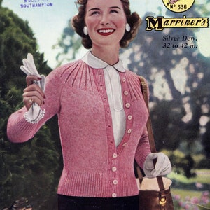 May include: A pink knitted cardigan with a white collar and buttons. The cardigan is being modeled by a woman with a smile. The image also includes text that reads "Marriner's Silver Dew. 32 to 42 in."