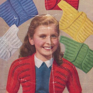 May include: A vintage image featuring a young person wearing a red bolero sweater. Several other bolero sweaters in blue, white, yellow, and green are displayed around the person. The sweaters have a short sleeve design and a textured knit pattern.