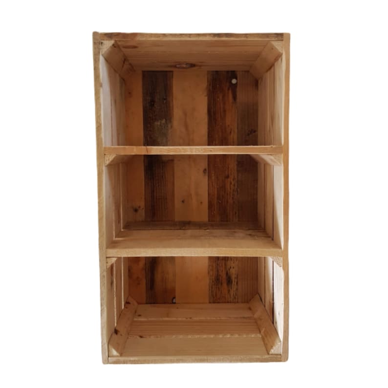 May include: A wooden shelving unit with three compartments, constructed from reclaimed wood. The unit displays a variety of natural wood tones. Ideal for storage or display, it adds a rustic charm to any room. The unit measures approximately 60cm in height.