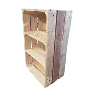 May include: A wooden bookshelf with three shelves, constructed from reclaimed wood. The design features natural wood tones and a mix of light and dark shades. The bookshelf is a simple, functional piece, suitable for displaying books or decorative items.