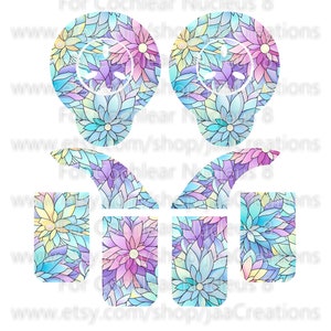 May include: Two light blue, floral patterned, Cochlear Nucleus 8 processor covers. The covers are shaped like a light bulb and have a floral pattern with pink, yellow, and blue flowers. The covers are for Cochlear Nucleus 8 processors.