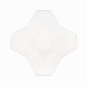 May include: A white, star-shaped box with a geometric design. The box is made of a translucent material and has multiple facets. The symmetrical design and defined edges give it a modern appearance.