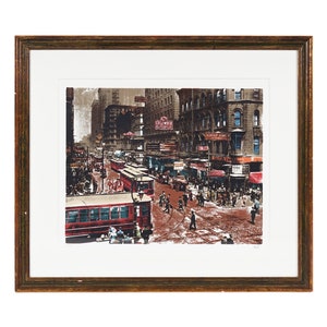 May include: A vintage-style print depicting a bustling city street scene with red trams, pedestrians, and shop fronts. The print is framed in a brown wood frame.