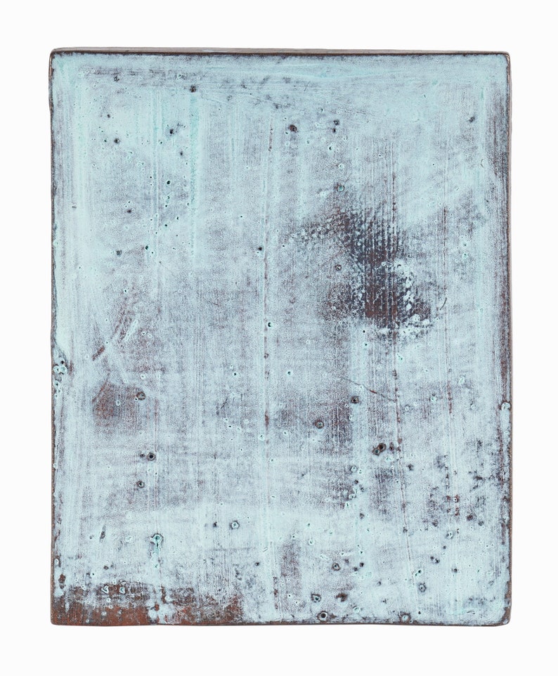 May include: A light blue, rectangular wooden sign with a distressed, aged look. The surface has a light blue paint with a white wash, showing the wood grain underneath. The edges of the sign are slightly rounded.