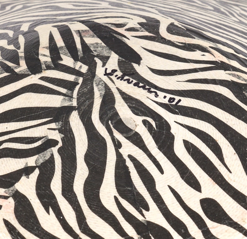 May include: Black and white zebra patterned bowl with a signature that reads "S.Hawkins '01".