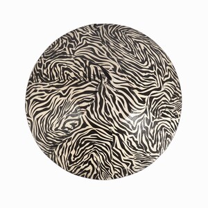 May include: A round, black and white zebra print decorative plate.