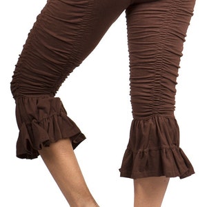May include: Brown capri leggings with a ruffled hem. The leggings are made of a soft, stretchy fabric and have a comfortable fit.
