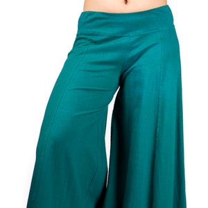 May include: Teal wide-leg pants with a high waist and a flowing silhouette.