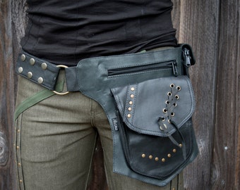 May include: Black leather hip bag with a flap pocket, zipper pocket, and studded accents. The bag is attached to a belt with a large metal ring and a green strap. The bag has the word "Mishu" on it.