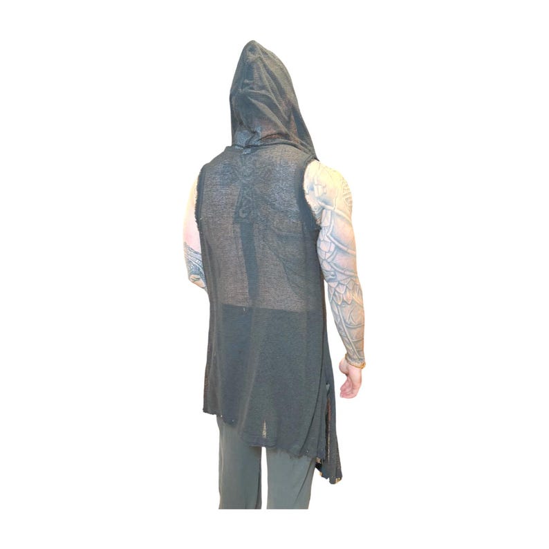 May include: A sleeveless, dark gray hooded vest with a distressed hem. The vest is long, reaching below the waist, and has a loose, flowing fit. The fabric appears to be lightweight and slightly sheer. The back of the vest features a subtle, textured pattern.